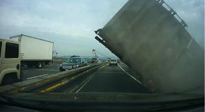 driver-miracle-escape-as-scrap-toting-truck-topples-over